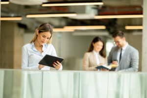 Woman uses tablet to review sample questions for a board evaluation.